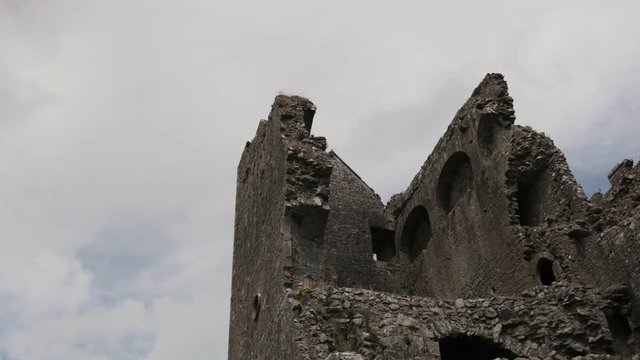 Ancient buildings crumble with age at Rock of Cashel in Ireland. Popular tourist destination and historic location famous for the Round Tower and Cormac's Chapel. Former home of kings.
