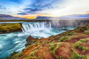 Fantastic sunset scene of powerful Godafoss waterfall.