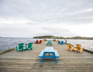 Beautiful colorful chairs next to the ocean  near harbour in lunenburg Nova scotia