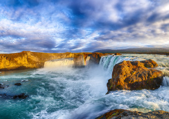 Breathtaking sunset landscape scene of powerful Godafoss waterfall