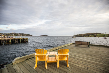 Fototapeta na wymiar Yellow chair in the harbour in Lunenburg Nova scotia