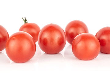 Group of seven whole fresh red tomato isolated on white background