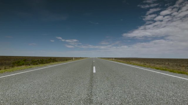 Large truck approaches from the distance on a remote road