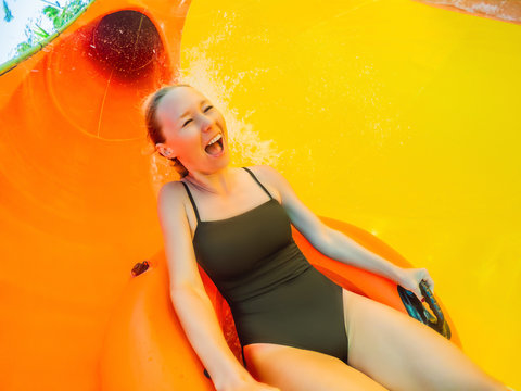 happy child have fun on water slike on outdoor swimming pool