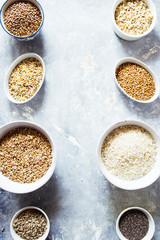 Variaty of raw cereals  on  bowls, top view flat lay,lentils, bulgur and quinoa, hemp seed,sunflower seeds ,brown rice, rice, healthy food concept , clean eating and detox concept.