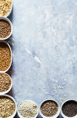 Variaty of raw cereals  on  bowls, top view flat lay,lentils, bulgur and quinoa, hemp seed,sunflower seeds ,brown rice, rice, healthy food concept , clean eating and detox concept.