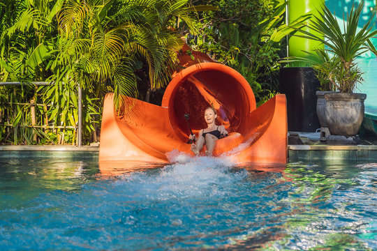 happy child have fun on water slike on outdoor swimming pool