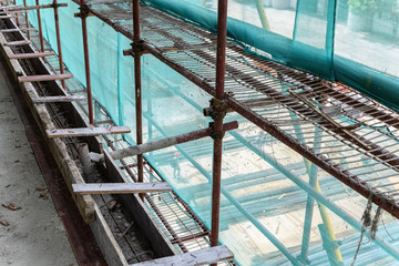 inside of an unfinished building with protection scaffolding and netting surrounde
