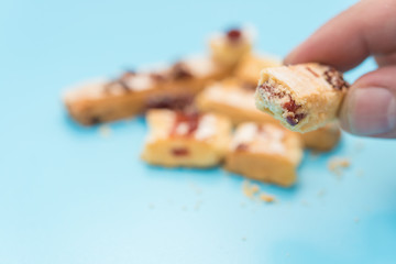 eating sweet pastry with cranberry on blue background