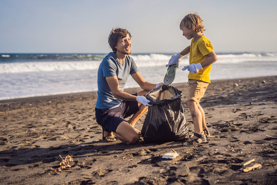 Dad and son are cleaning up the beach. Natural education of children