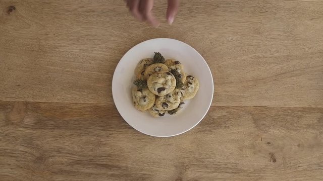Stopframe placing buds in cookies