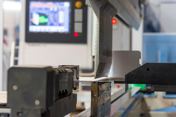 operator bending metal sheet by sheet bending machine