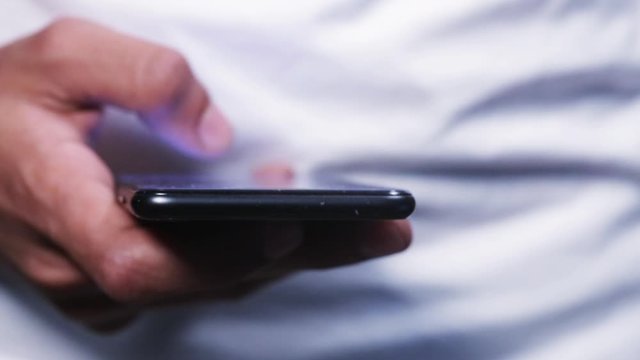 man's hand using smart phone with likes hovering over the screen	