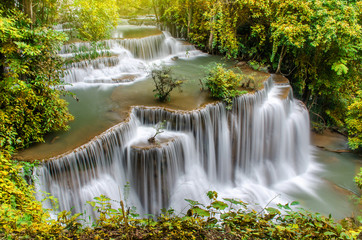 Fototapeta premium Travel to the beautiful waterfall in tropical rain forest, soft water of the stream in the Huai Mae Khamin Waterfall level 4, Khuean Srinagarindra National Park, Kanchanaburi, Thailand 