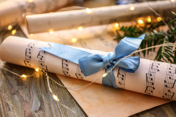 Christmas composition with music notes on wooden table