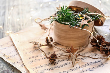 Christmas composition with music notes and box on table