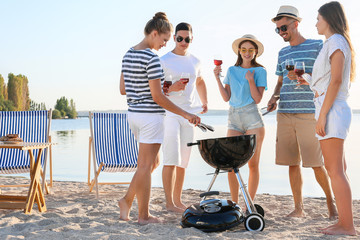 Friends at barbecue party near river