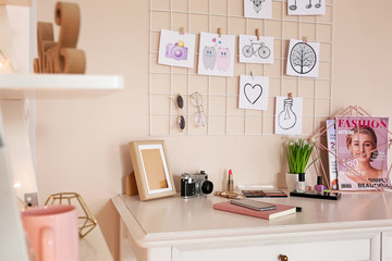 Comfortable workplace with mood board in room