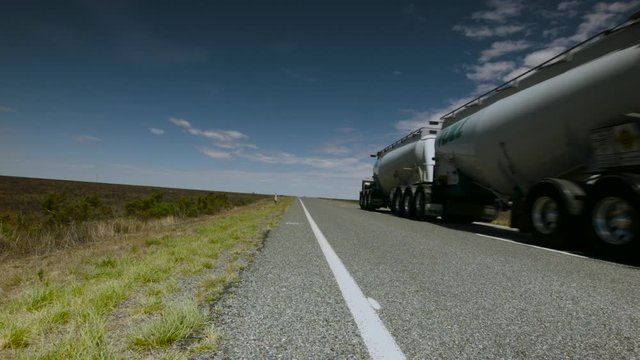 Truck passes by on empty country road
