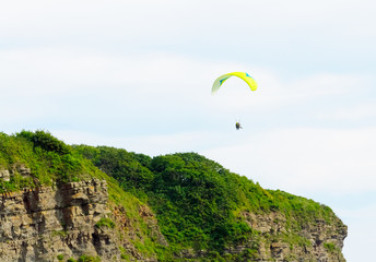 People paraglide on a sunny day.