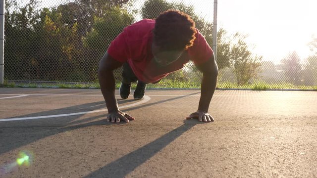 African American man working out by doing burpees