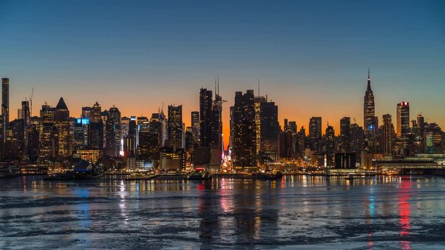 Midtown Manhattan skyline at sunrise in New York, timelapse of rising sun