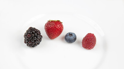 Blackberry, raspberry blueberry and strawberry on a white background. Vitamins and wholesome foods