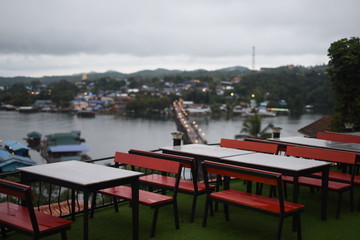 Fototapeta premium View of the river and surrounding communities of the dam near the Mon Bridge at Khao Laem Dam, Sangklaburi, Thailand.