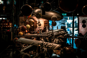 Fototapeta na wymiar Lots of old toys together with small hot air balloons hanging, planes and airships softly illuminated. Concept of nostalgic memories.