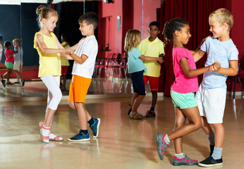 Children trying partner dance in class