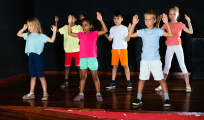 Children studying modern style dance in class
