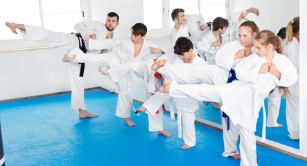 Fototapeta na wymiar Children trying martial moves in karate class