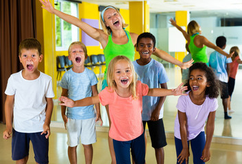 Positive children in dance studio smiling and having fun