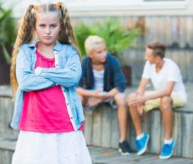 Upset girl after quarrel with playmates