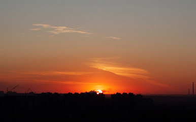 Scarlet sunset in autumn city 