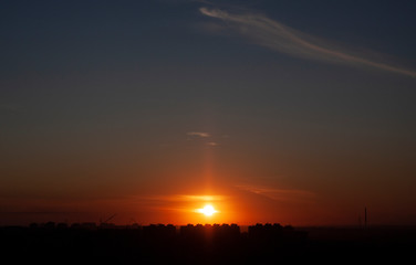 Scarlet sunset in autumn city 