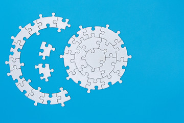 White jigsaw puzzle on blue background, Copy space.