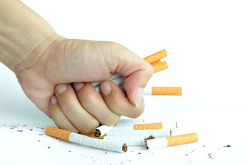 hand of man holds a cigarette in his hand. In order to stop smoke cigarettes is addictive. Health...