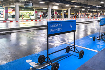 Blue label priority parking sign for car parking in shopping mall.