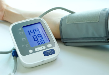 Man check blood pressure monitor and heart rate monitor with digital pressure gauge. Health care and Medical concept