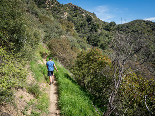 Obraz premium Boy hiking on Jesusita Trail, Santa Barbara, California, USA