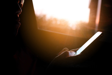 Silhouettes of women using mobile phones Evening time