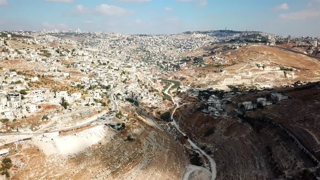 Aerial footage over  East Jerusalem Palestinian neighborhood jabel mukaber and Wadi Kidron