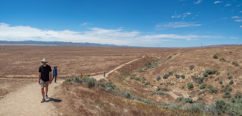 Family walking at Wallace Creek Trail, San Andreas Fault, Carizzo Plain National Monument on sunny spring day, Kern County, California, Central Valley