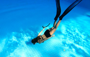 Underwater images of women diving deep