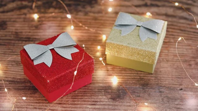 festive golden fairy lights around Christmas gift boxes going on and off