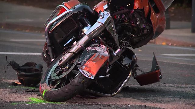 Aftermath of a motorcycle crash. Helmet lying in road