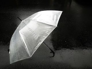 Umbrella in raining day. Umbrella is lying on the street.