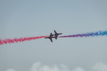 Planes cross paths very closely in aerobatic flight