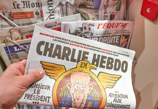 A hand holding Charlie Hebdo